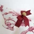 Detail of Dog Adelaide, red ribbon bow with a gold domed metal button.
