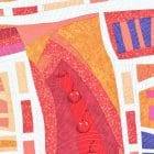 Detail of the textile art canvas Passages. Piece of red fabric with cherries in the center of other pieces of fabric.
