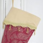 Detail of the Christmas stocking Lady Guinevere with fringe of gold beads.