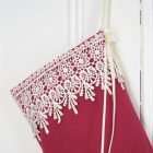 Detail of the Christmas stocking Princess Cyrielle, ivory lace cuff on a red background.