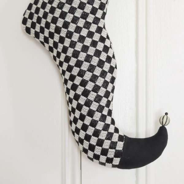 Detail of the elf stocking Sherpa, curved foot with black ultra-suede tip, white bead black striped.