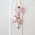 Trio of hearts in red and white fabric, embroidery of birds, wooden beads.