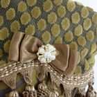 Elf stocking Zefirino detail: brown satin bow with jewel of pearls and stones.
