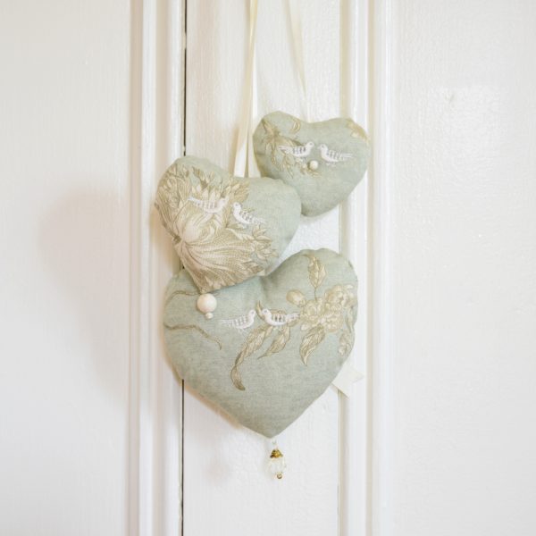 Hanging trio of hearts in green and ivory toile.