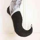 The curved foot of the elf stocking Estrella in black textured velvet with white organza trim and silver bead.