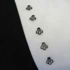 Detail of the pillow Trace of history, openwork buttons on ivory velvet