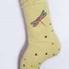 Dragonfly on the ankle of the Christmas stocking Zana