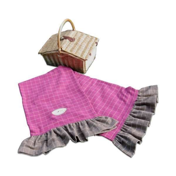 Pink and taupe throw with a picnic basket
