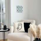 Textile artwork Equilateral on a wall above an armchair