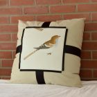 Cushion The nightingale in front of a red brick wall