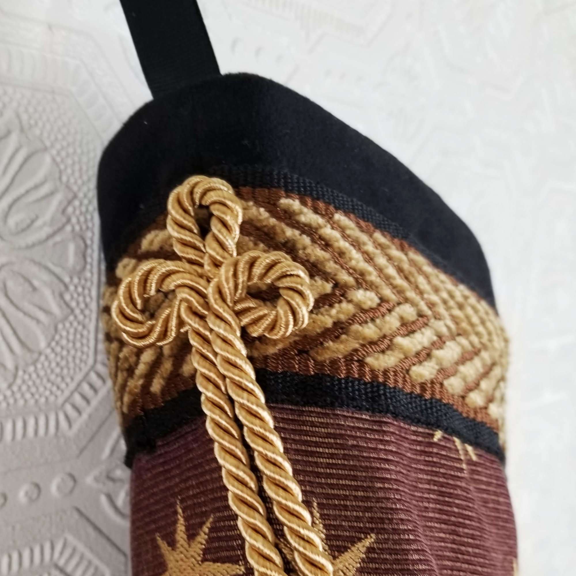 Detail of Melchior Christmas stocking, triple gold cord loop