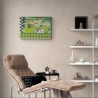 Textile artwork Le 3e rang on an off-white wall above a lounge chair and beside a shelf.