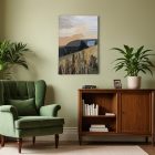 Textile wall art J'irai jusqu'à toi on the wall of a room with a green armchair and a wooden cabinet with books and a green plant.