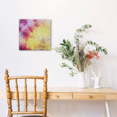Art textile contemporain dans un décor. Tableau Souvenir d'un rêve au-dessus d'un pupitre avec un bouquet de feuillage.